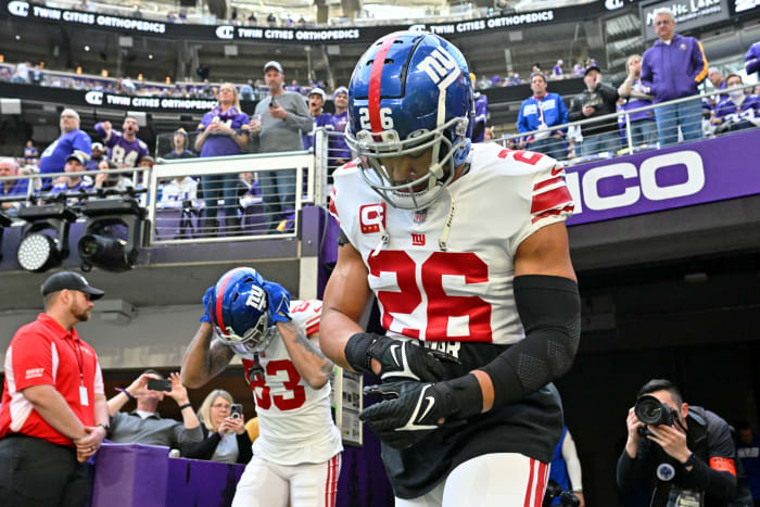 Jan 15, 2023; Minneapolis, Minnesota, USA; New York Giants running back Saquon Barkley (26) runs onto the field before a wild card game against the Minnesota Vikings at U.S. Bank Stadium.
